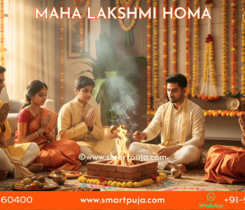 A happy Indian family sitting together for Maha Lakshmi Homa at home with a Vedic Pandit.