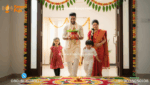 Happy Indian family performing Griha Pravesh Puja rituals with Kalash and Havan in their new home.