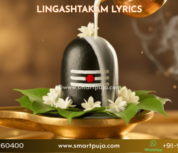 A beautifully decorated Shiva Lingam being worshipped with bilva leaves and milk during Lingashtakam chanting